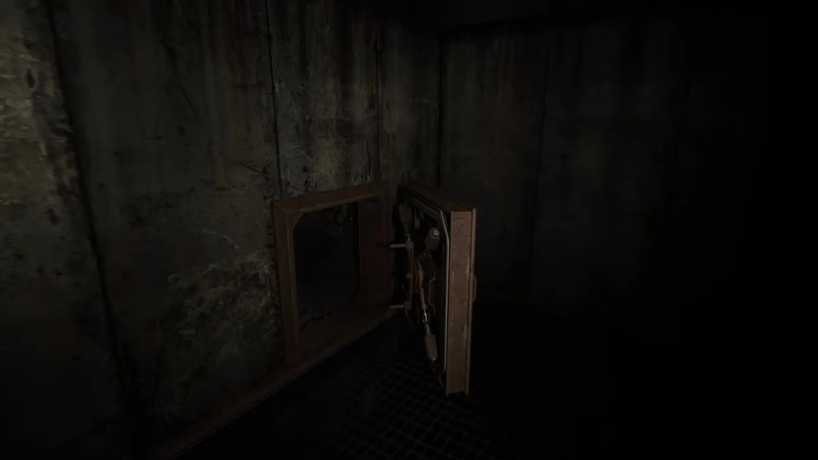 Sealed industrial door with a large orange valve wheel mounted beside it in a concrete tunnel