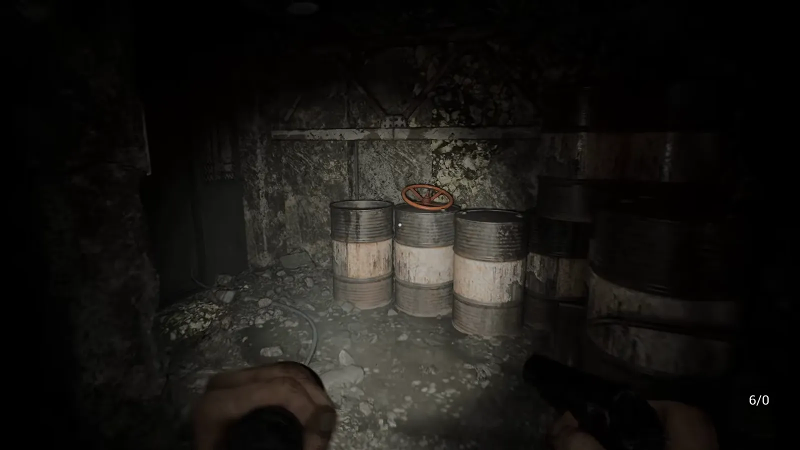 Cluster of storage barrels in a dark warehouse-style room with minimal background lighting
