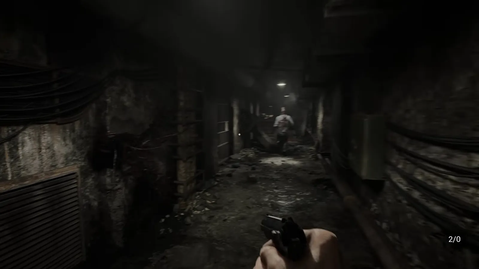 First-person view aiming a pistol down a dark corridor with an on-screen ammo counter reading x over nine